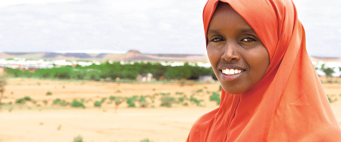 A girl with an orange scarf wrapped around her head and neck