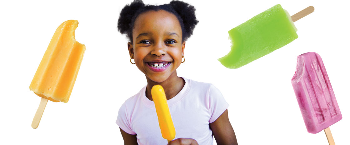 a girl smiling while holding an ice pop, with different ice pops behind her