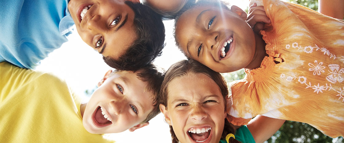 a group of kids smiling in a huddle