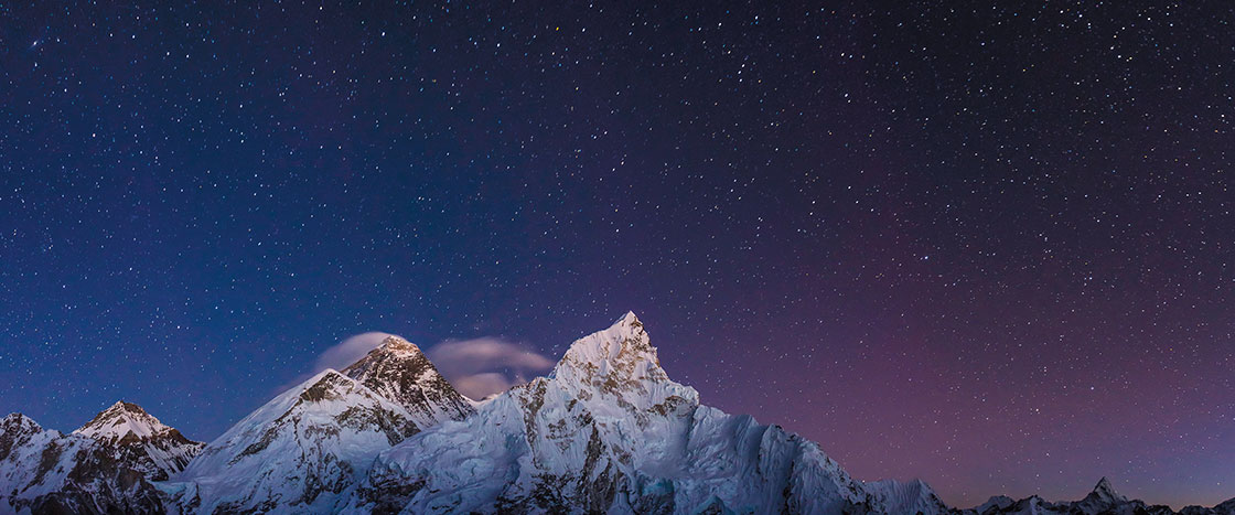 Mount Everest in front of a starry sky