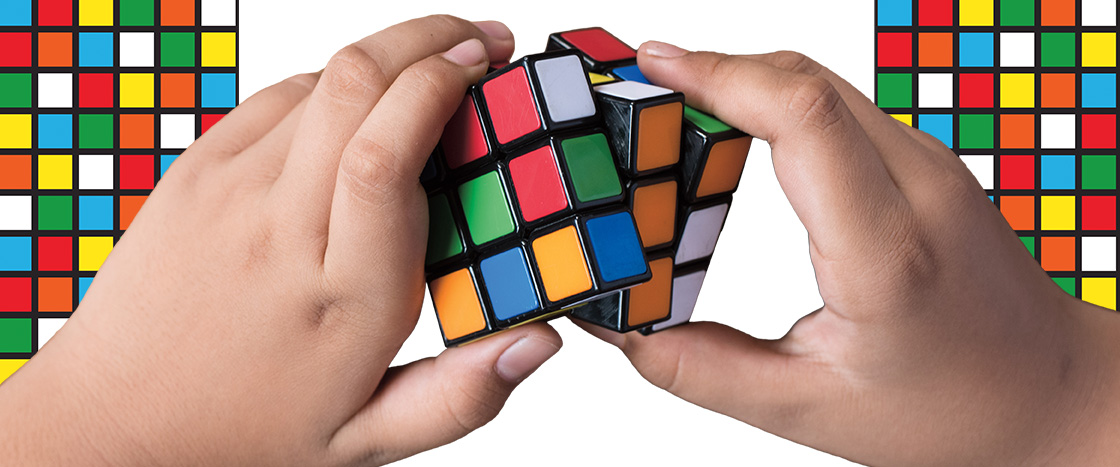 Image of hands solving a rubik&apos;s cube