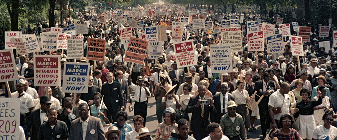 Image of people marching & protesting with signs